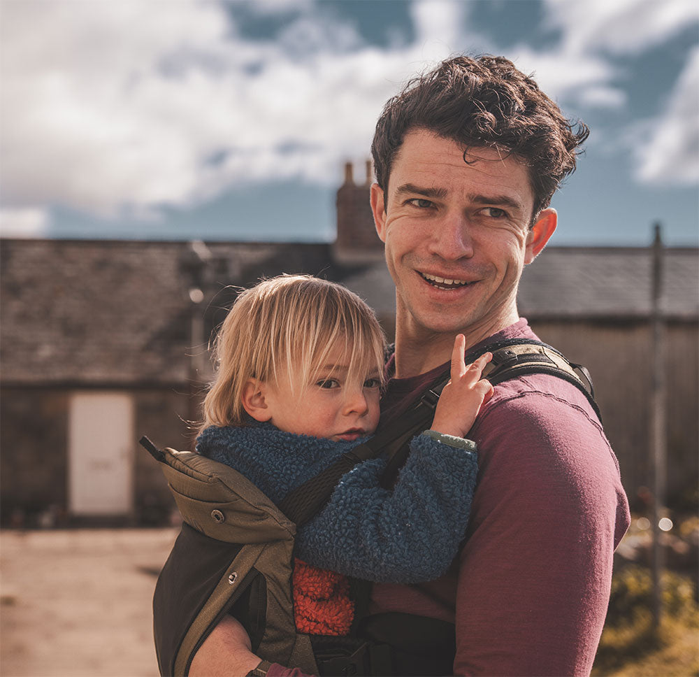 Ben Leonard carrying his toddler in a TUKO carrier